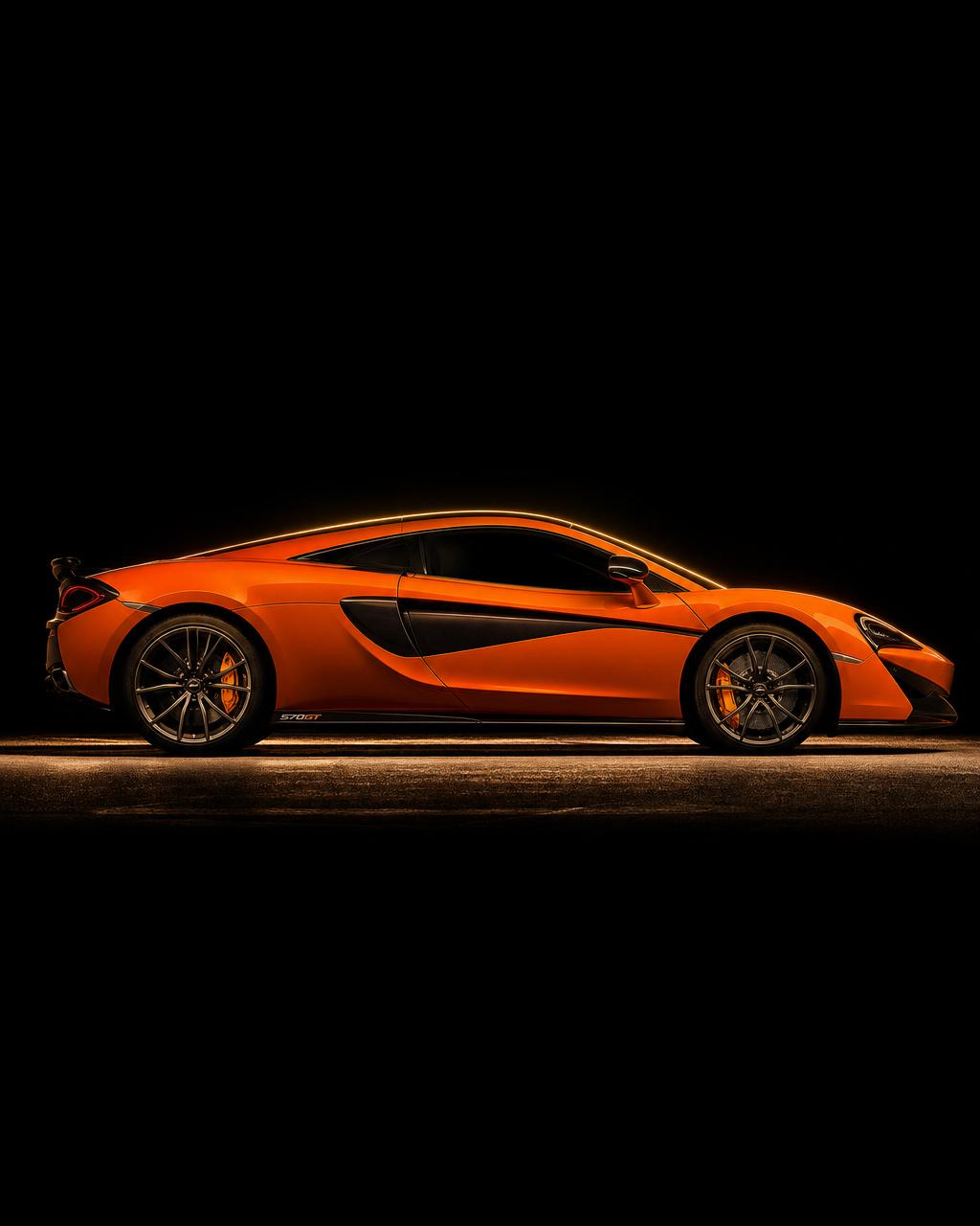 McLaren 570GT in orange with dramatic rim lighting
